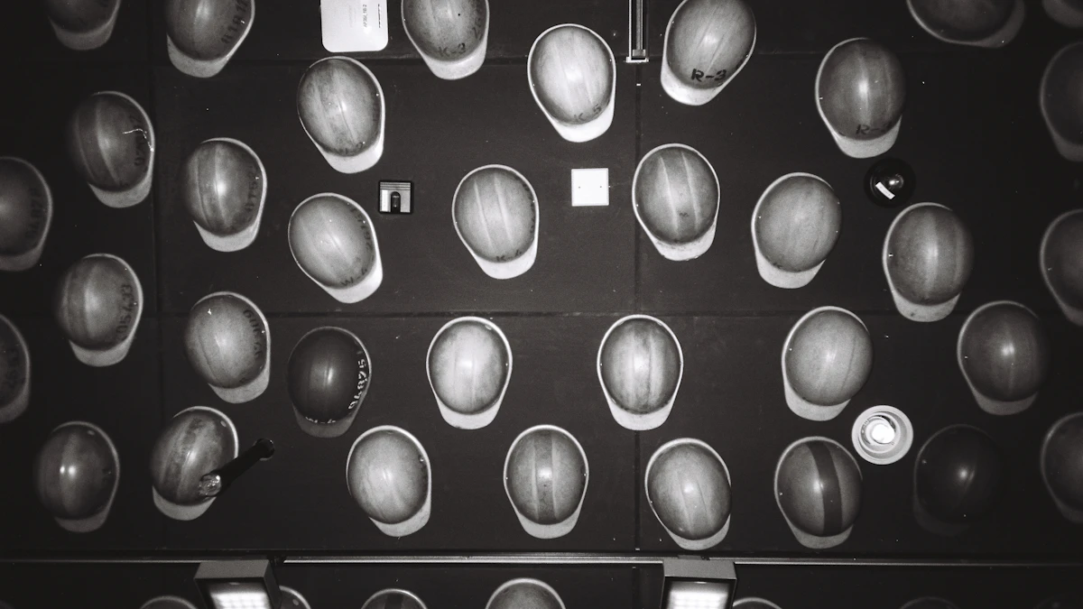 Black and white photo of many hard hats hanging in rows on a dark wall
